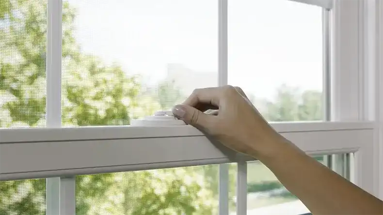 Woman unlocks a Marvin Replacement double hung window