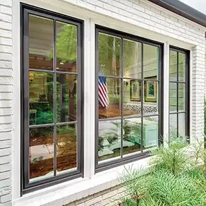 Exterior view of brown casement windows with divided lites on a white brick home