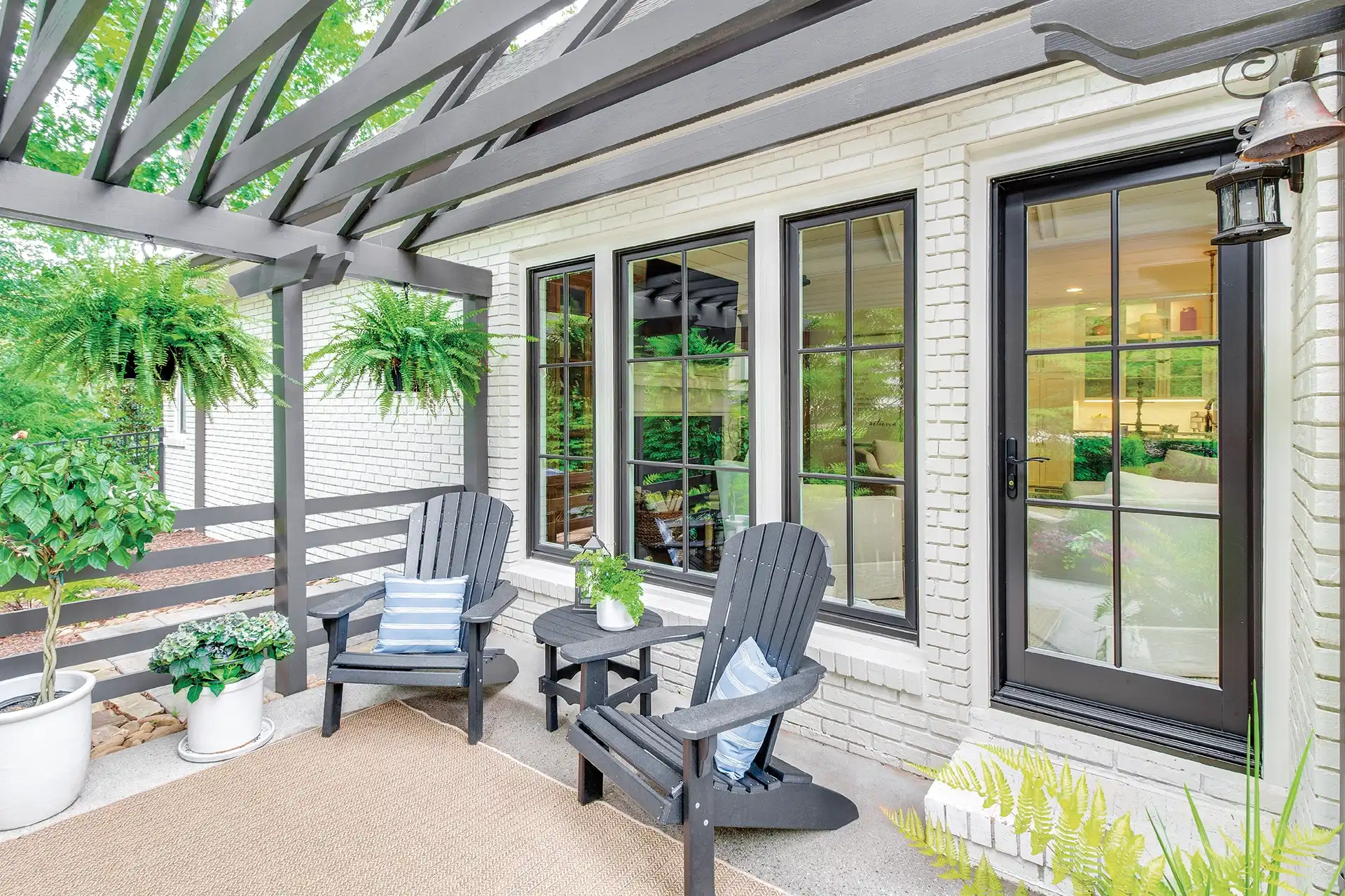 Exterior patio image featuring Casement Windows, a Picture Window, and an Inswing French Door in Bronze exterior finish with Oil Rubbed Bronze hardware.
