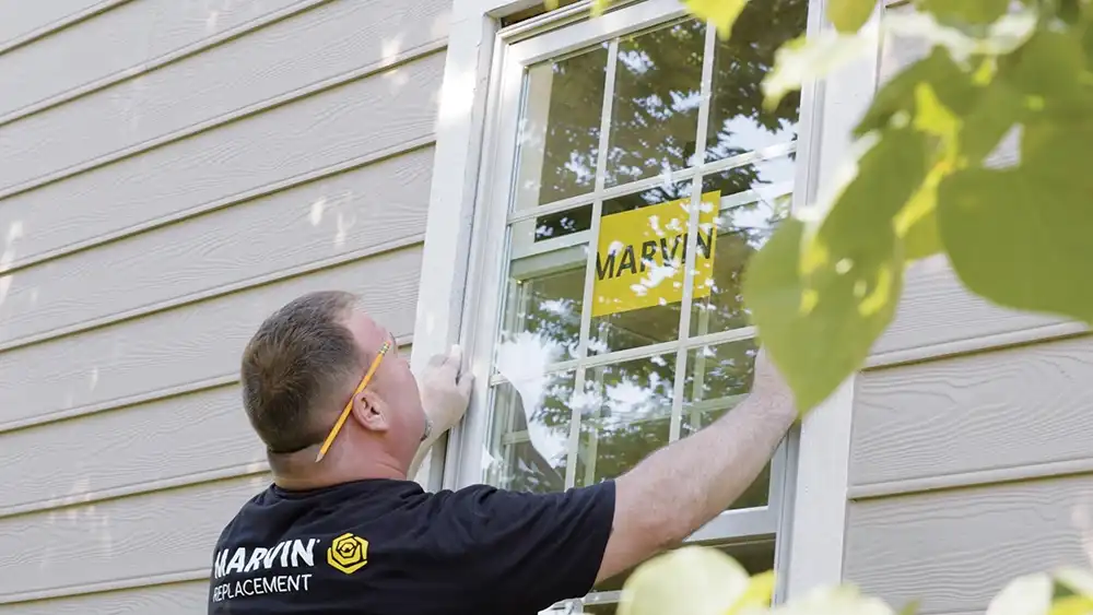 Marvin Replacement window installer places a window