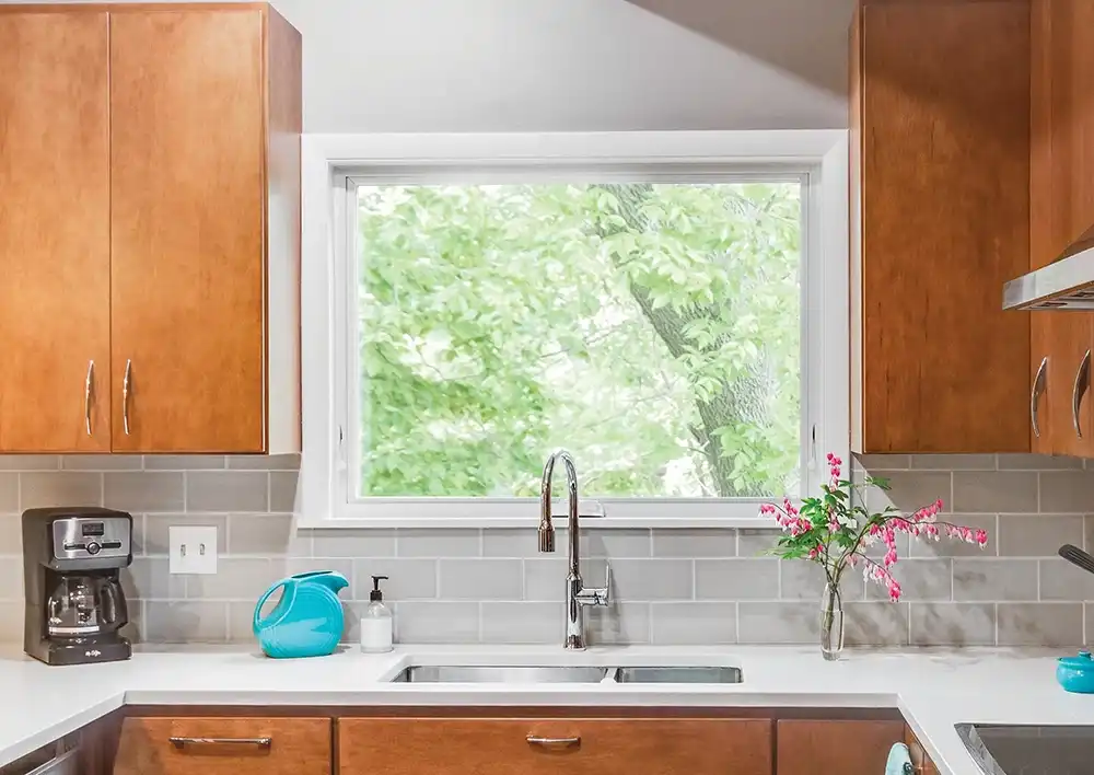 Interior view of a Marvin Replacement white awning window above a kitchen sink.
