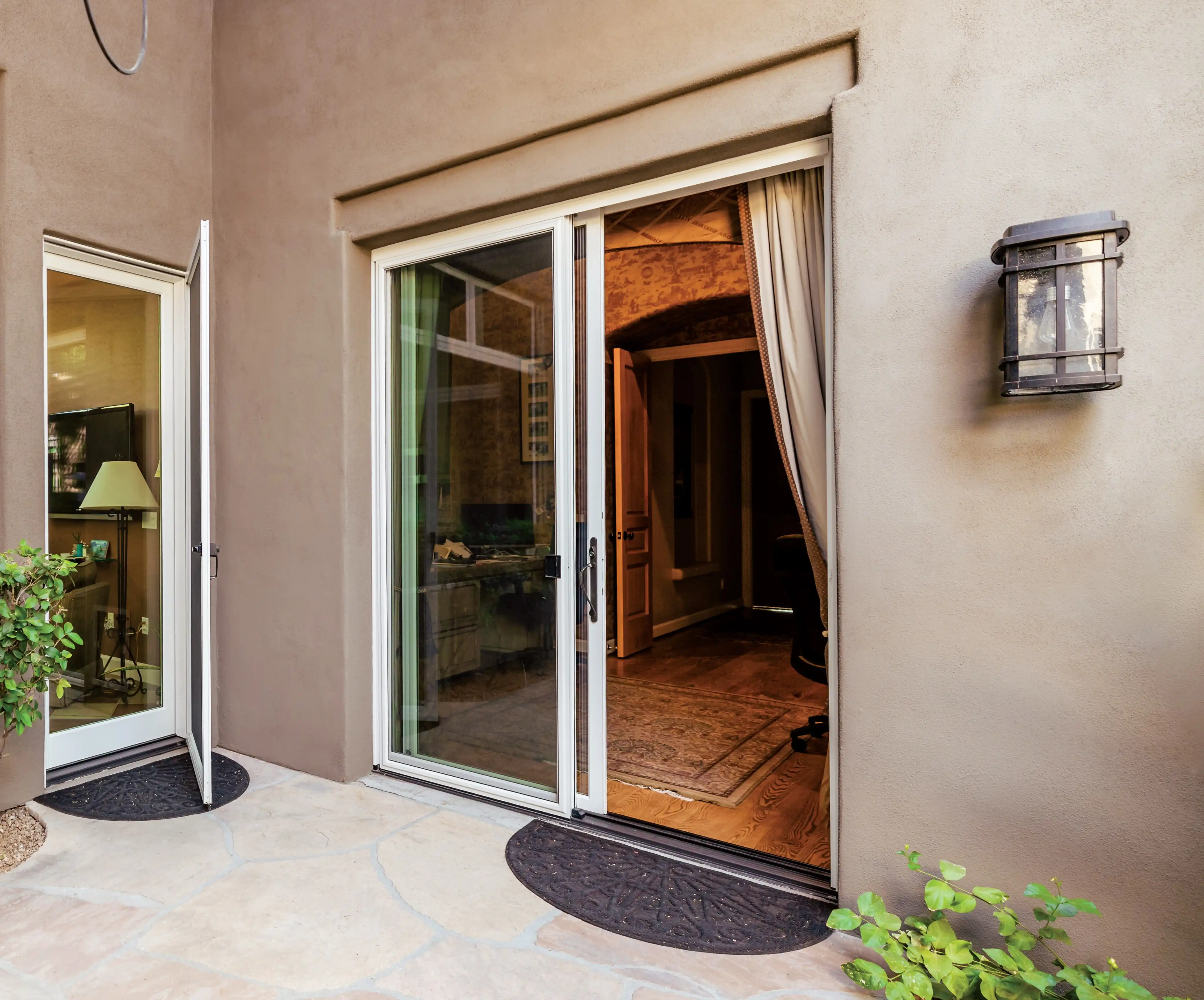 Exterior view of a white Marvin Replacement two-panel Sliding Glass Patio door.
