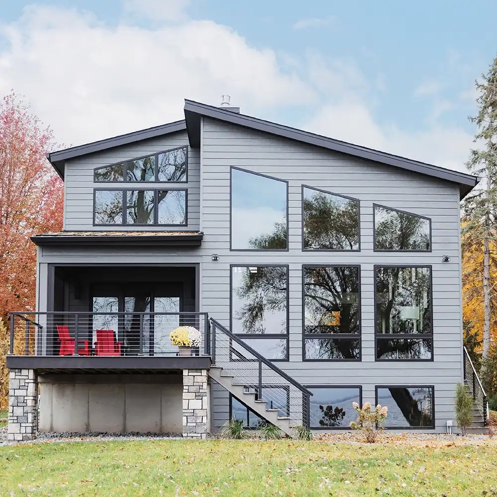 Exterior view of a home with black Marvin Replacement special shape windows.