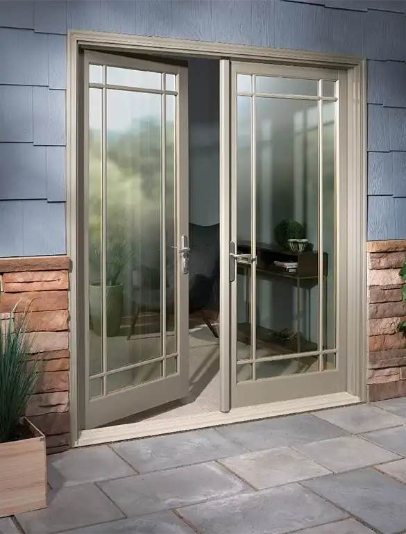 Exterior patio image featuring a 2-panel open Inswing French Door with Prairie 9-Lite Simulated Divided Lites in Pebble Gray exterior finish with Brushed Chrome hardware and a Beige sill