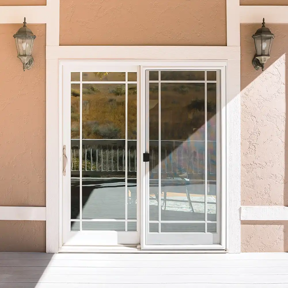 Exterior view of a white two-panel Marvin Replacement sliding French door with prairie grilles.
