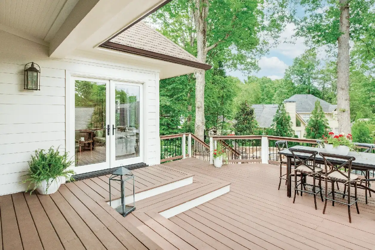 Exterior deck image featuring an Inswing French Door in Stone White exterior finish with Oil Rubbed Bronze hardware.