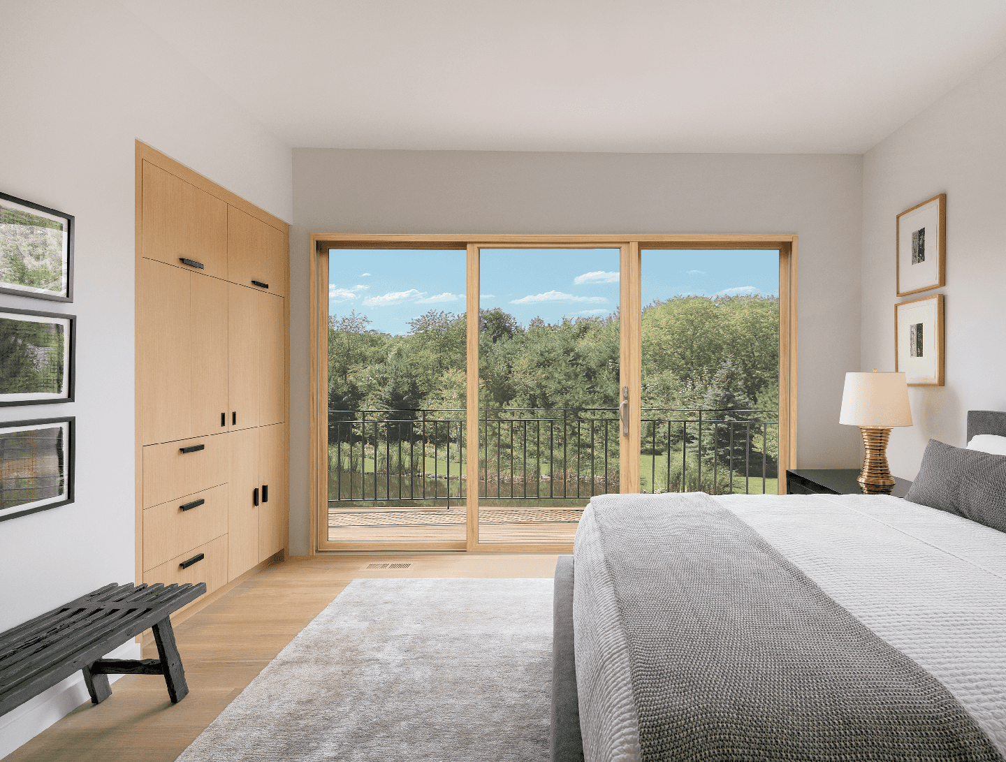 Interior bedroom image featuring a 3-panel Infinity Sliding Patio Door in EverWood interior finish with Satin Taupe hardware and a Beige sill.