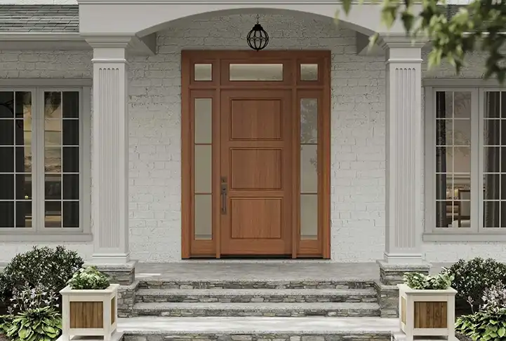 Street view of a TruStile Traditional Front Door in Nutmeg color on a white home with two columns.