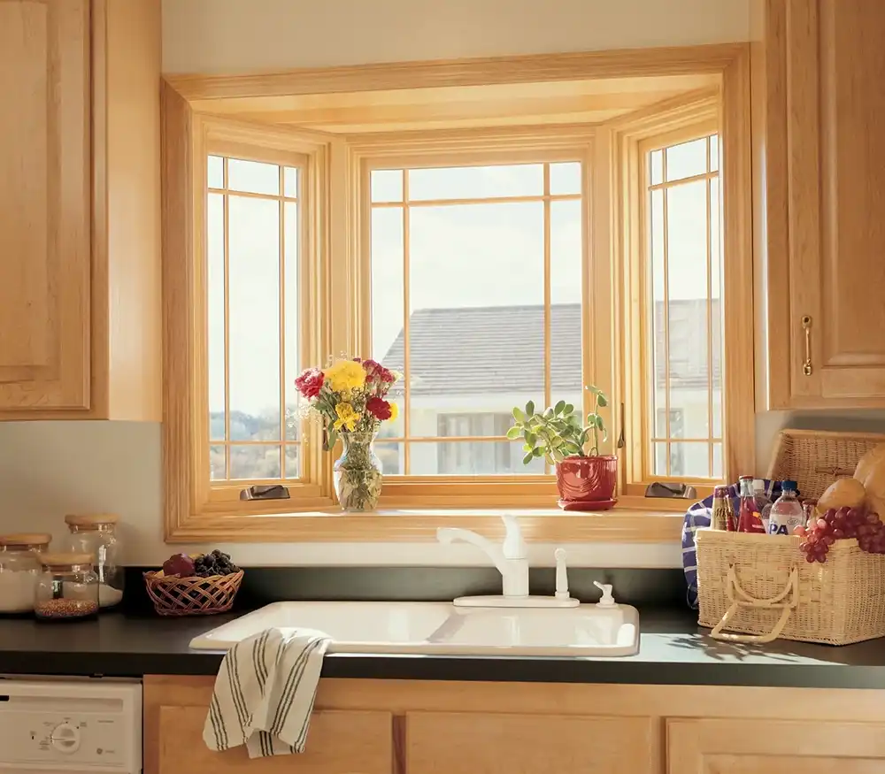 Interior view of a Marvin Replacement bay window with EverWood finish above a kitchen sink.