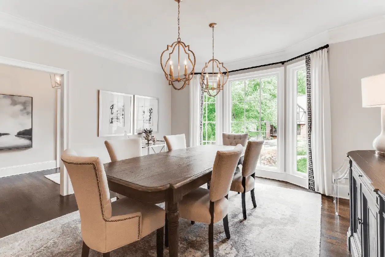 Interior dinning room image featuring Infinity Casement Windows and an Infinity Picture Window in Stone White interior finish with White hardware.