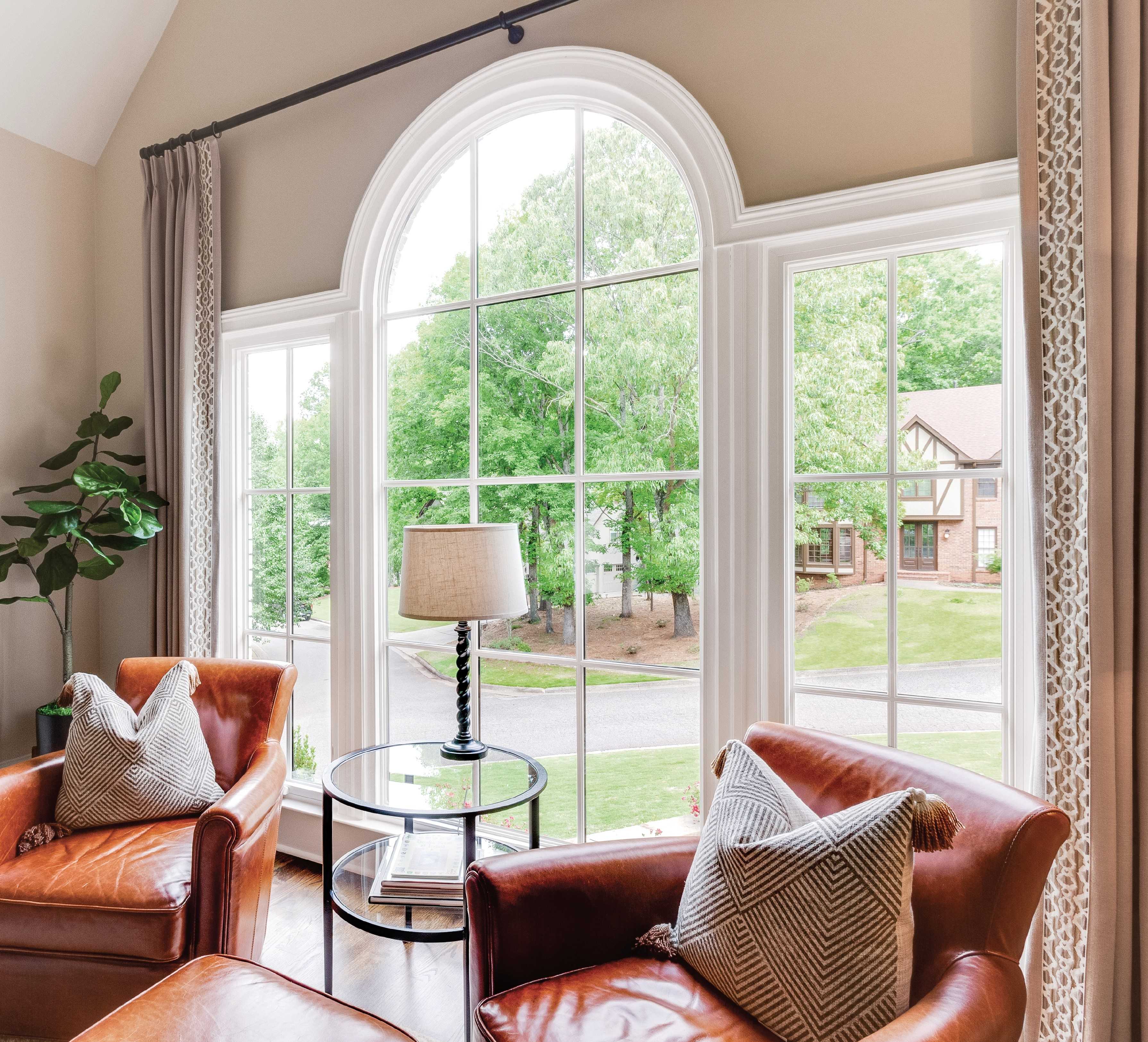 A round top window assembly in a living room.