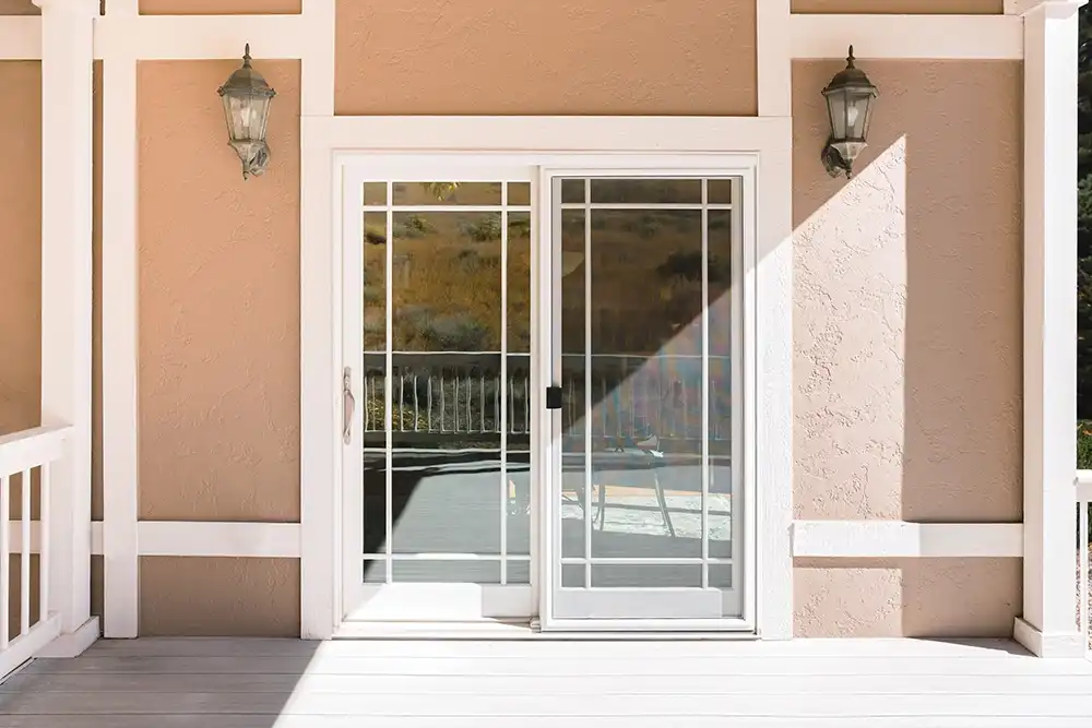 Exterior view of a white Marvin Replacement Sliding French door with Prairie style divided lites.